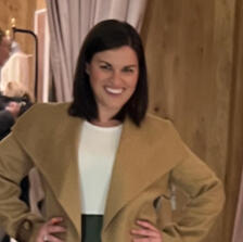 Personal Shopping testimonial for working with Personal Stylist Lena Piskorowski from client in Canton, MI woman poses with a big smile on her face in her new clothes, wearing a camel colored wide lapel collared coat and white form fitting t-shirt
